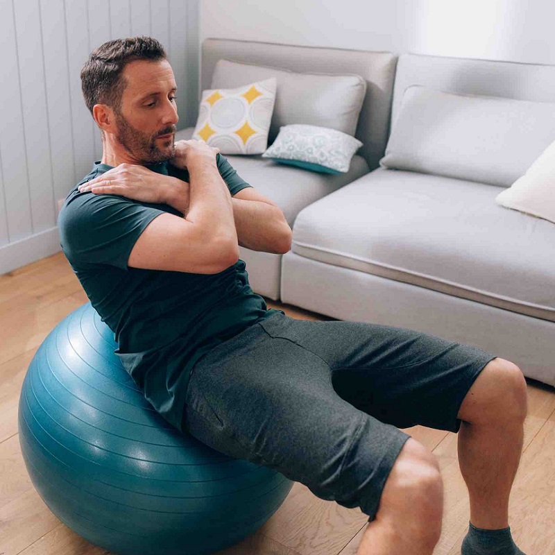 a man is doing exercises with a pilates ball